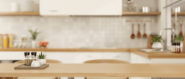 istock Copy space for displaying your product on a wooden dining table in a minimalist Scandinavian kitchen 1908494104