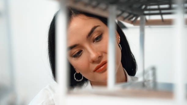 istock Closeup of young skilled architect checks the house model structure. Immaculate. 1908505871