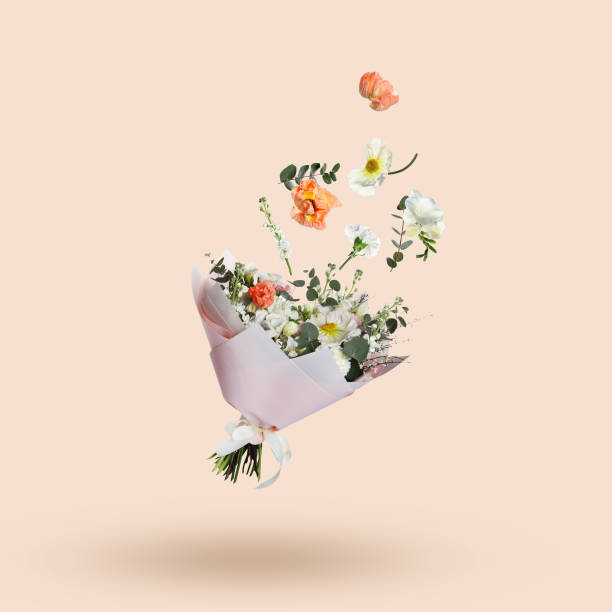istock Different flowers falling into beautiful bouquet on beige background 1908551709
