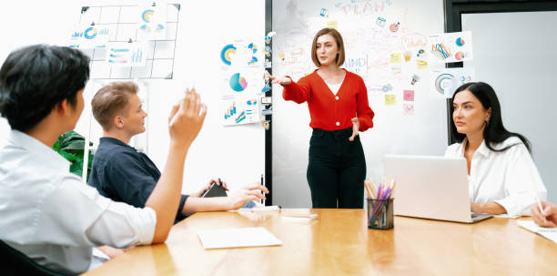 istock Male manager raise hand while asking question at business meeting. Immaculate. 1908552763