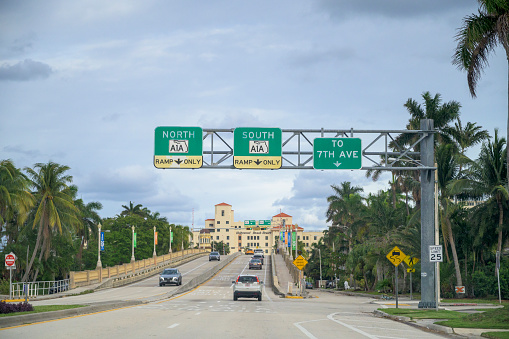 Street view with vehicles in shot, North and South A1A exit signs.