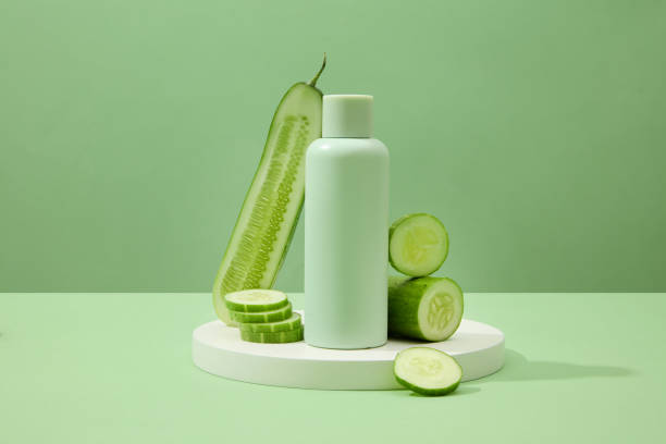 istock An unlabeled cosmetic bottle and fresh cucumbers are placed on a circular white podium against a pastel green background. Concept of vegan cosmetics. 1908561031