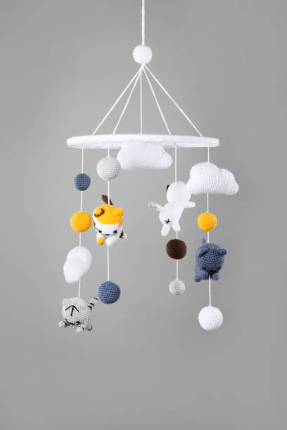 istock Cute baby crib mobile on grey background 1908563125
