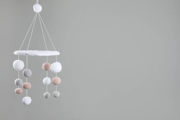 istock Cute baby crib mobile on grey background. Space for text 1908563126