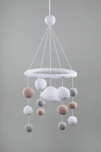 istock Cute baby crib mobile on grey background 1908563136