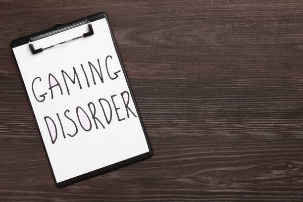 istock Clipboard with phrase Gaming Disorder on wooden table, top view. Space for text 1908564210