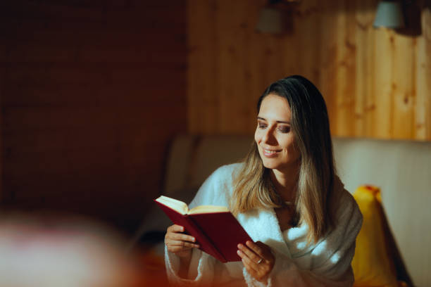 istock Happy Woman Reading a Book on Vacation Feeling Carefree 1908587998