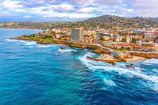 Aerial view of the coastal community of La Jolla, California approximately 10 miles north of downtown San Diego shot via helicopter from an altitude of about 300 feet over the Pacific Ocean.