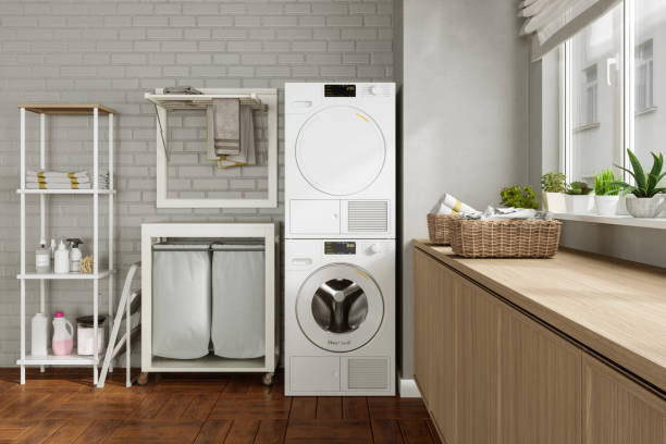istock Laundry Room With Washing Machine, Dryer, Laundry Basket, Folded Towels, Drying Rack And Potted Plants 1908622155