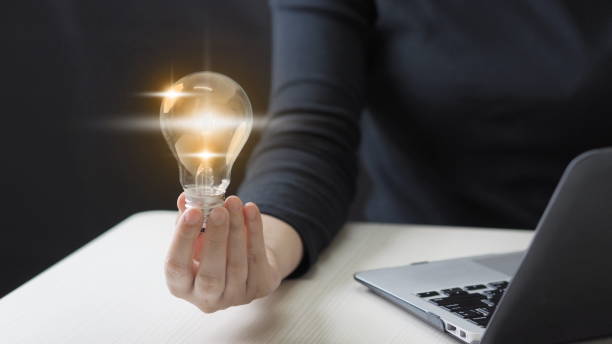 istock Businessman holding glowing lightbulb and human icon thinking with copy space for creative thinking idea and problem solving concept. 1908648901