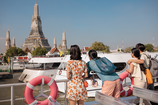 Rear view of people enjoying sightseeing the city from the boat.