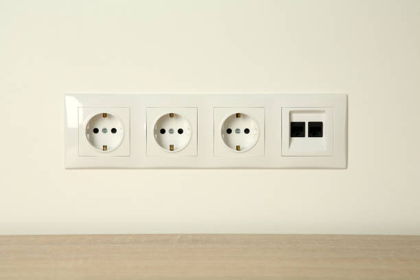 istock Many power sockets with ethernet plate on white wall indoors 1908687610