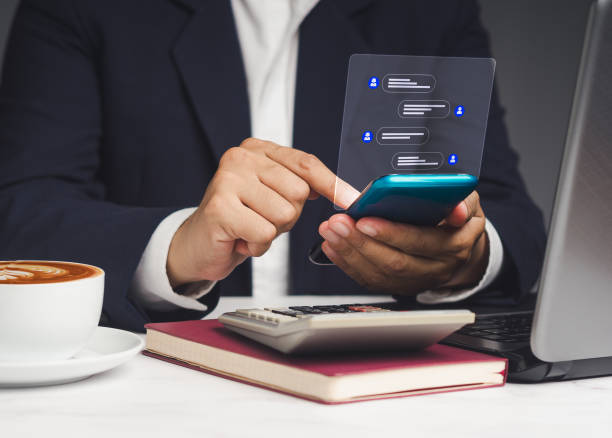 istock Businessman typing on a mobile phone with live chat chatting on application social networks while sitting in the office. 1908688647