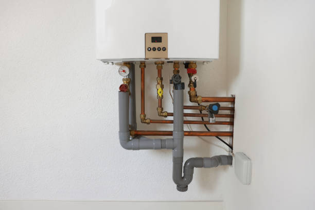 istock Modern gas boiler on white wall indoors 1908689720