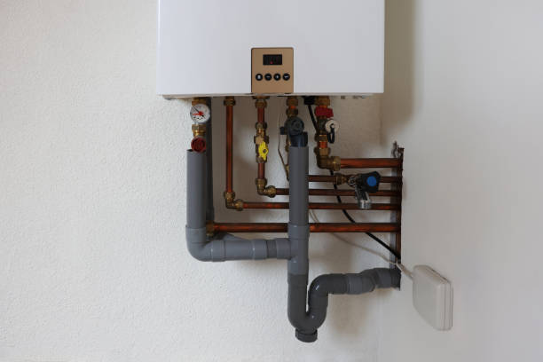istock Modern gas boiler on white wall indoors 1908690234