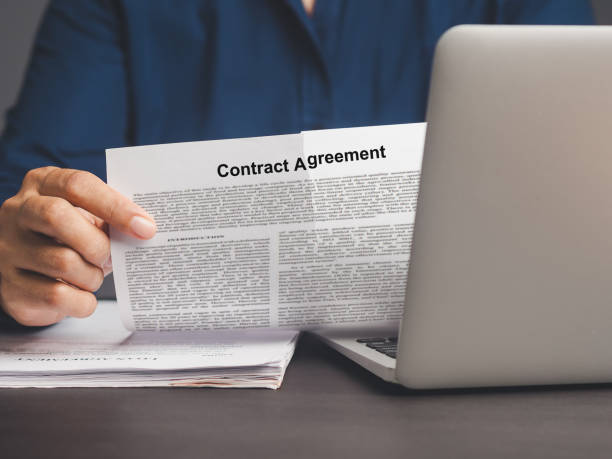 istock Businessman tearing up a contract agreement while sitting at a desk. 1908690946