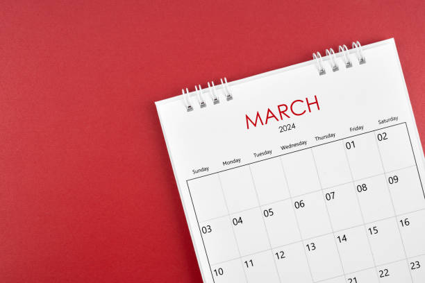 istock March 2024 desk calendar on red background. 1908691895