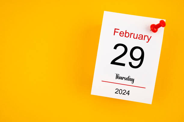 February 29th calendar for February 29 and wooden push pin on yellow background. February 29th calendar for February 29 and wooden push pin on yellow background. Leap year, intercalary day, bissextile. afternoon picture stock pictures, royalty-free photos & images