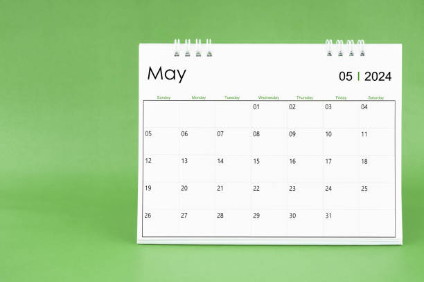 istock May 2024 desk calendar isolated in green background. 1908692420