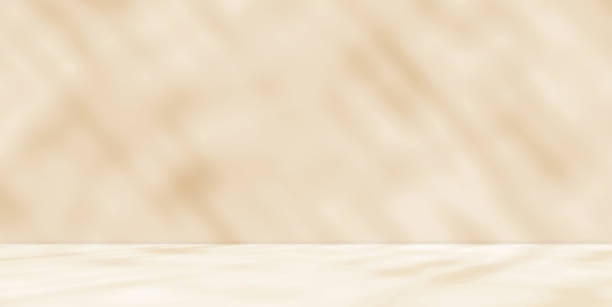 istock Empty cream beige orange room studio with shadow of leaves for product presentation. 1908696208