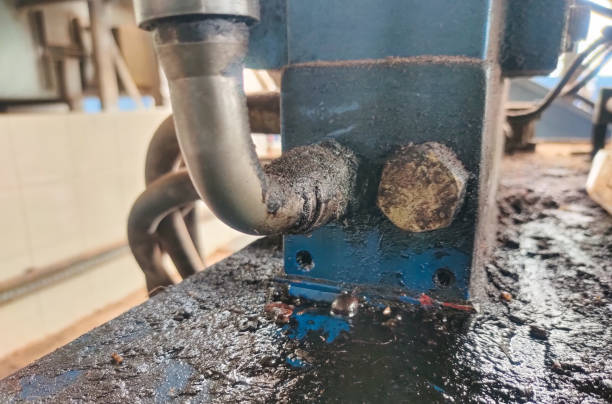 istock Closeup oil from a leaking hydraulic hose 1908718684