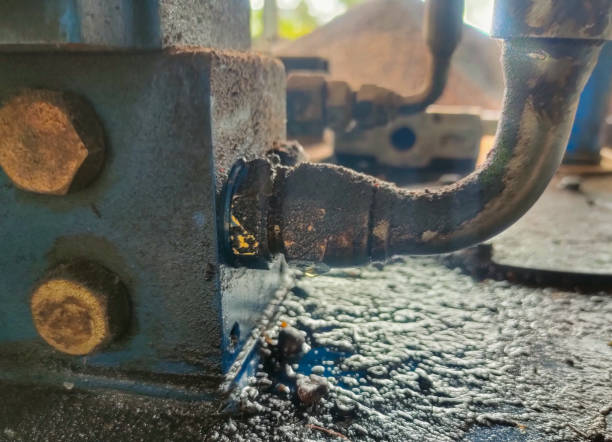 istock Closeup oil from a leaking hydraulic hose 1908718685