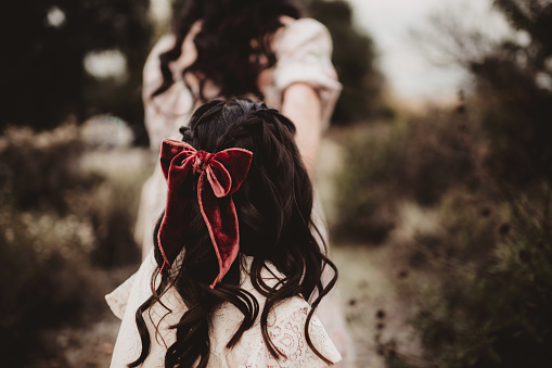 Back of little girl's head with velvet bow