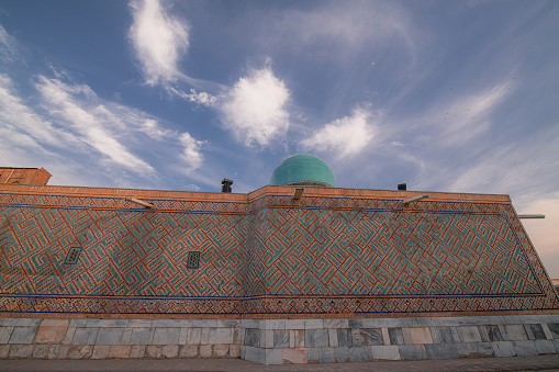Close up on the dome of the Madrasah on Registan square, Samarkand, Uzbekistan. Sunset sky, copy space for text