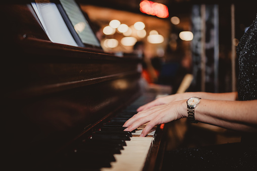 Woman's hands playing the piano at a church