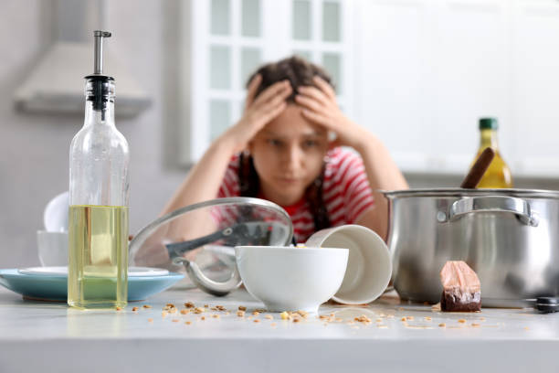 istock Stressed woman in messy kitchen. Many dirty dishware and utensils on table, selective focus 1908760972