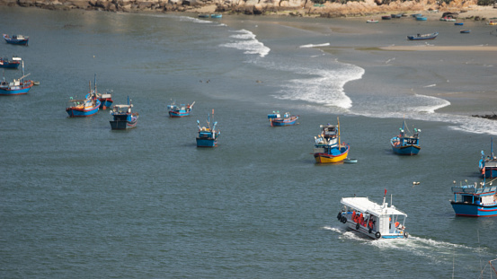 Beautiful scenery of Phan Rang, beaches with wooden boats, wind power poles in rice fields