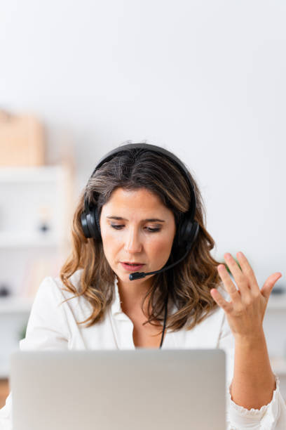 istock Woman using headset during an online meeting from home 1908855265
