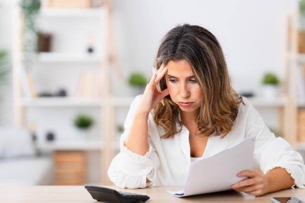 istock Woman looking stressed out while calculating home finances 1908855269
