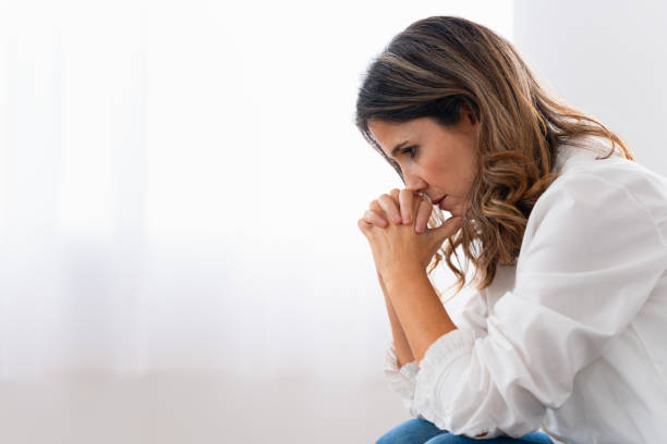 istock Sad woman sitting alone crestfallen at home 1908856853
