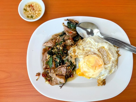 a photography of a plate of food with a fork and spoon.