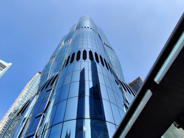 Low angle view of the Henderson skyscraper in Hong Kong Central district, an under construction 190 mt tall skyscraper designed by Zaha Hadid Architects. The tower's exterior is inspired by a blossoming bauhinia, the flower that has appeared on Hong Kong's flag since Britain handed control of the territory back to China in 1997.