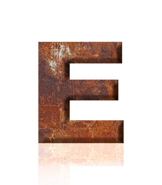 istock Isolated shot of three-dimensional rusty metal alphabet letter E on white background 1908906739