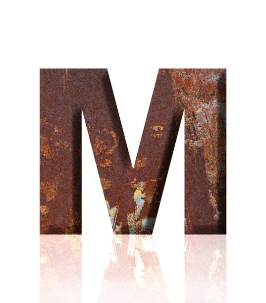 istock Isolated shot of three-dimensional rusty metal alphabet letter M on white background 1908906746