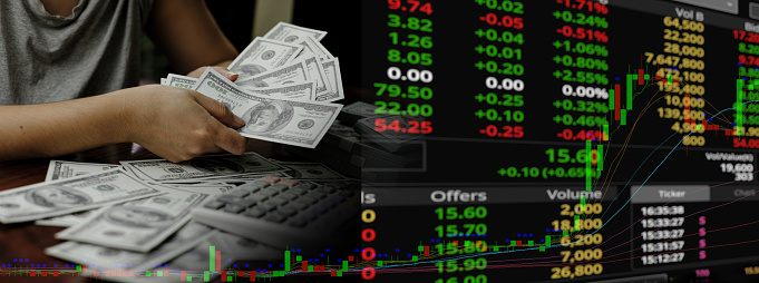 A person holding money Hand holding 100 US dollars banknotes on a trading chart background