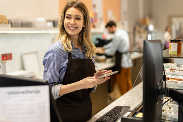 istock Smiling young baker at the checkout counter. 1908931105