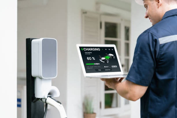 istock Qualified technician working with laptop for home EV station. Synchronos 1908942699