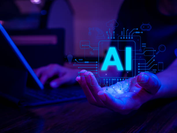 istock AI futuristic technology transformation concept. AI chip in hand while work with laptop computer. Artificial intelligence innovation and global online network connection for access to digital service. 1908961097