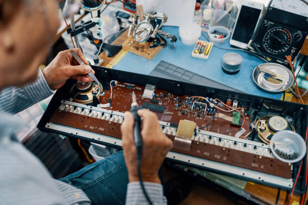 istock Senior man repairing an electronic music keyboard 1908965869
