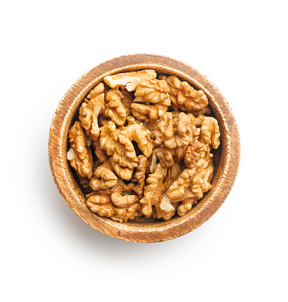 Peeled dried walnut kernels  in bowlisolated on the white background.