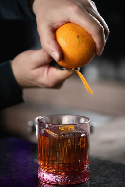 istock Bartender Enhances Negroni Cocktail with Orange Peel 1909001448