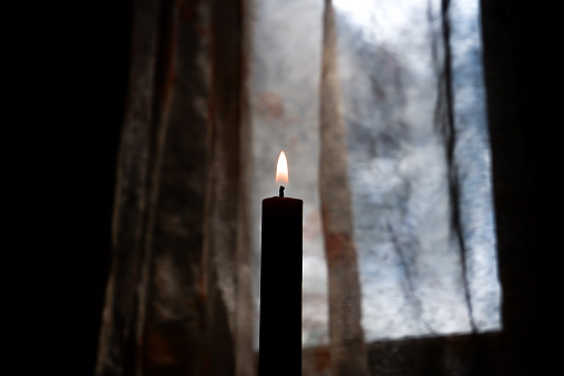 candles burning in a room with minimal light