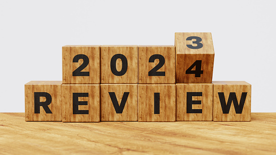 2023 and 2024 Annual review, business and customer review. Learning, improvement, planning and development concept. Wooden cubes flips from 2023 Review to 2024 Review. 3d illustration