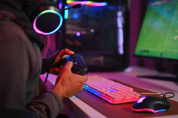 istock Young holding a joystick playing video game online in exciting neon atmosphere. 1909015193
