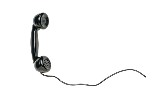 Retro handset with insulated wire on a white background. Vintage equipment.