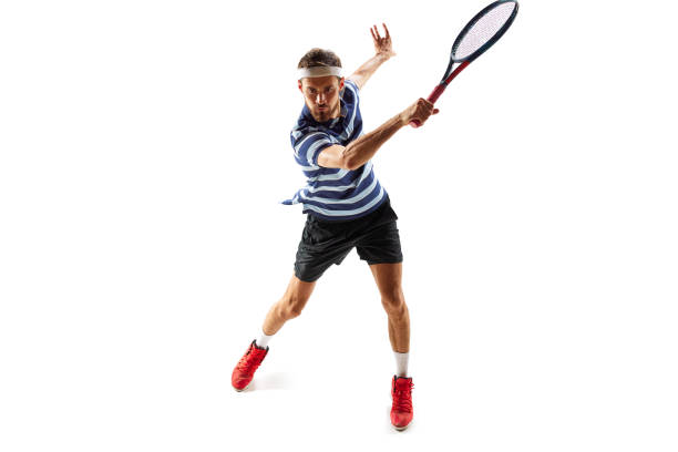istock Ambitious and concentrated man, tennis player in motion, practicing, hitting ball with racket, training isolated over white background. Sport 1909046597